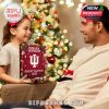 A little girl hands over the Indiana Hoosiers 2025 Advent Calendar, emphasizing the product as a heartfelt gift in a festive living room setting!