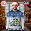 Man wearing an Indianapolis Colts Grinch Christmas sweater stands in front of a tree and fireplace in a festive indoor holiday setting!