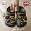 Hand holding Iowa Hawkeyes clogs showing lightweight design and holiday Jibbitz details!