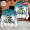 Dual display of the Jaguars ugly sweater with matching front and back Grinch design, festive color fade, and decorative winter patterns!