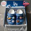 Blue Dodgers clogs with baseball and snack-themed charms in official gift box.