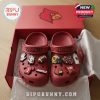 Red Louisville Cardinals clogs with football themed charms inside branded box.