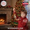 Boy holding cat king ornament from advent calendar by Christmas tree in cozy festive room!