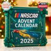A close-up of a green NASCAR-themed 2025 advent calendar box with racing illustrations and holiday decorations in the background!