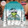 Front view of a Christmas sweater featuring the Grinch wearing a Miami Dolphins Santa hat with festive holiday graphics and team branding!