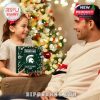 Child presenting the Michigan State Spartans Advent Calendar 2025 in a cozy Christmas setting!