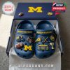 Michigan Wolverines Crocs with themed charms in a team-colored box on a soft carpet!