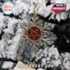 Silver snowflake ornament with red pentagram hanging on a snowy Christmas tree branch!