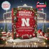 Christmas tree adorned with Nebraska Football themed decorations including a helmet, player, shoes, and jersey in red and white colors!