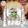 Back of a white and gold New Orleans Saints Christmas sweater with Grinch artwork, festive snowflakes, and bold lettering!