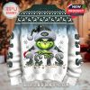 Back of a Christmas sweater featuring a Grinch wearing a Jets Santa hat with festive winter graphics and full team branding!