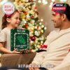 Smiling child giving her dad a North Texas Mean Green themed Christmas calendar surrounded by tree lights and holiday cheer!