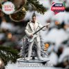White-suited Rammstein guitarist Christmas ornament hanging on decorated tree.