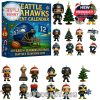 A collection of miniature ornaments styled as Seahawks football players, mascots, and festive icons, all laid out to showcase what’s inside the advent calendar!