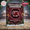 A close shot of a maroon-colored calendar box with holiday lights and snowflakes, prominently displaying the University of South Carolina Gamecocks branding for 2025!