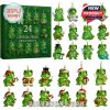 Festive green crystal frog collection with gold hanging loops, playful character designs, and cheerful holiday-themed outfits arranged next to a matching green display box!