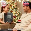A child presenting a Walking Dead 2025 Advent Calendar gift to her father in front of a brightly lit Christmas tree!