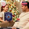 Little girl holding The Who advent calendar offers it as a present to her dad, capturing a sweet holiday moment by the Christmas tree!