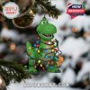 Rex-style ornament with string lights wrapped around its body, hanging from a decorated Christmas tree in snowy holiday ambiance!