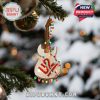 U2 guitar ornament hanging on a decorated tree with bokeh snow background, glowing lights wrapped around for a vibrant music-inspired holiday feel!