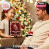 Combination of holiday cheer and school spirit as a daughter surprises her father with a calendar featuring mini athletes, mascots, and USC accessories, perfect for fans!