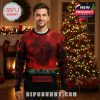 Man in a red and black Washington Commanders x Stranger Things ugly Christmas sweater in front of a decorated tree.