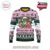 Back view of pink Grinch Christmas sweater with central illustration and holiday patterns.