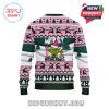 Product ad with Grinch sweater front and back views, branding, and pink Christmas logo.