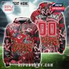 Customizable Kansas City Chiefs hoodie with red graffiti visuals, helmet logo, and name-number area on the back.