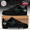 Green Bay Packers-inspired black sneakers with dark green swoosh and official team logos on the side heels.