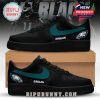 Black sneakers branded with Philadelphia Eagles logos and green color detailing.