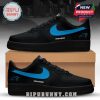 Black Carolina Panthers sneakers with blue swoosh and logo near the rear side of the shoes.