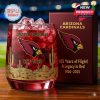 An Arizona Cardinals-themed whiskey glass with a desert design and vibrant red contents celebrating 105 years of the team’s legacy.