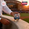 Texas Rangers whiskey glass with anniversary details rests on a stadium railing during golden hour.```