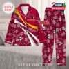 Arizona Cardinals pajamas laid on a bed with floral and team logos, showcasing custom name areas and holiday cheer!