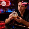 Man holding and looking at an Arizona Diamondbacks whiskey glass in a bar setting!