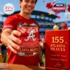 An Atlanta Braves supporter smiles while offering the anniversary whiskey glass with stadium decor and celebration details in the background!