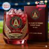 Atlanta United FC commemorative whiskey glass with gold phoenix wing design and custom collector’s box, honoring the team’s foundation and spirit.