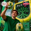 Austin FC whiskey glass lifted proudly in front of a bright team logo backdrop.