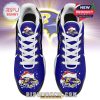 Top perspective of a pair of purple Ravensmas sneakers with Santa hat graphics and white shoelaces on a festive design!
