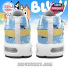 Back view of cartoon-themed sneakers with a yellow heel band and scattered blue paw prints on the fabric!