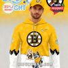 A man wears a bold yellow-and-white hoodie decorated with Bluey cartoon characters and the Boston Bruins logo, showcasing a fun and sporty mix!