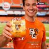A cheerful supporter in orange displays a bold whiskey glass with the Bowling Green Falcons logo and ice-cold drink, captured mid-game inside the stadium!