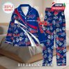 Blue Buffalo Bills pajamas laid on a bed with red-white striping, floral prints, and full team logo coverage for fans!