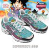 Anime sneakers with turquoise base, white laces, and detailed Dragon Ball graphics, shown in front of a colorful cartoon-style background featuring Goku!