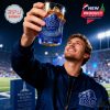 BYU fan holding a blue whiskey glass up high inside a football stadium!
