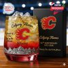 A collectible Calgary Flames whiskey glass and branded box displayed together in a sports stadium setting!