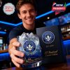 A glass with CF Montréal emblem and skyline illustration is held up by a smiling man inside a sports bar, alongside a deep blue gift box marked EST. 2010 and Limited Edition!
