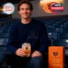 Chicago Bears athlete proudly holding whiskey glass with bold amber tones, skyline etching, and anniversary design in a sports training environment!