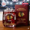 An anniversary whiskey glass honors the Blackhawks' century of excellence with detailed icons and a gold-lettered display box.